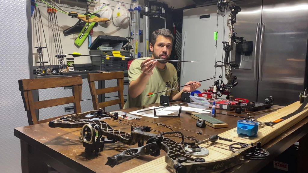Luis teaching arrow building at his workbench